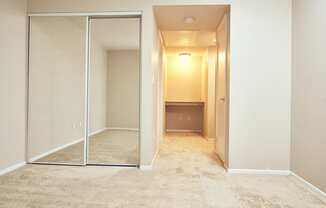 Alta Vista Apartments in Escondido, CA with Wall to wall carpet, mirrored closet, white walls, window