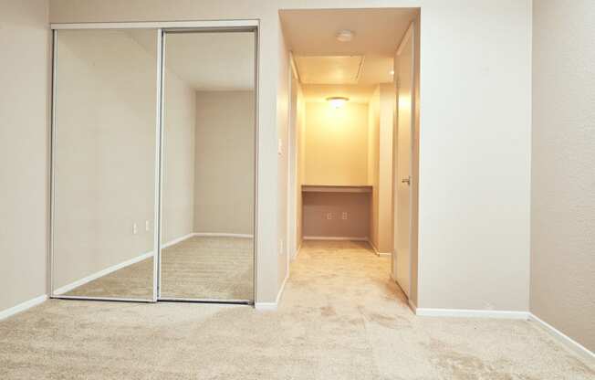 Alta Vista Apartments in Escondido, CA with Wall to wall carpet, mirrored closet, white walls, window