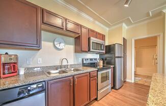 a kitchen with stainless steel appliances and granite counter tops