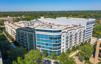an aerial view of a large building surrounded by trees