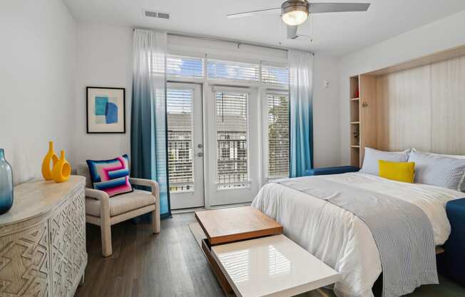 a bedroom with a bed and a sliding glass door at Link Apartments® Mint Street, Charlotte, North Carolina