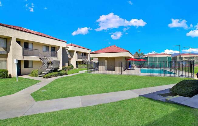 A sunny day at the apartment complex with a clear blue sky.