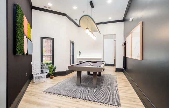 a game room with a shuffleboard table and a pool table