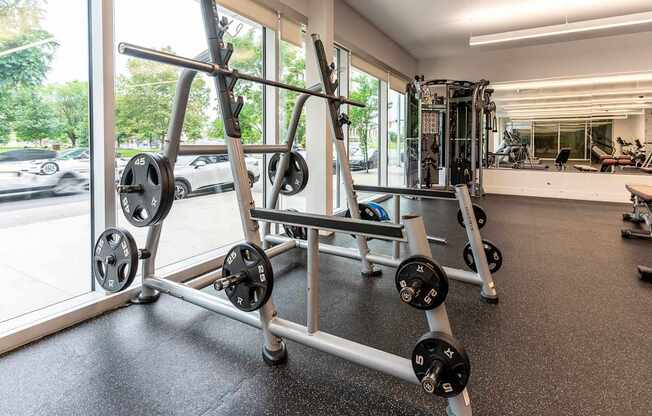 a gym with weights and cardio equipment in a building