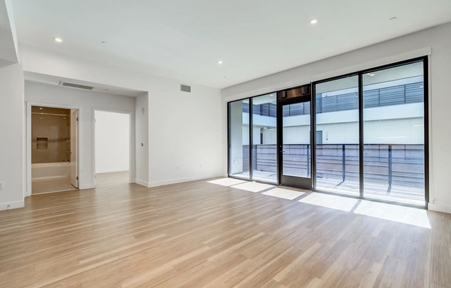 a living room with a large window and a door to a pool
