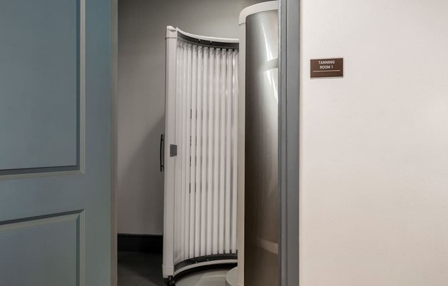 A white radiator is on the floor next to a wall.