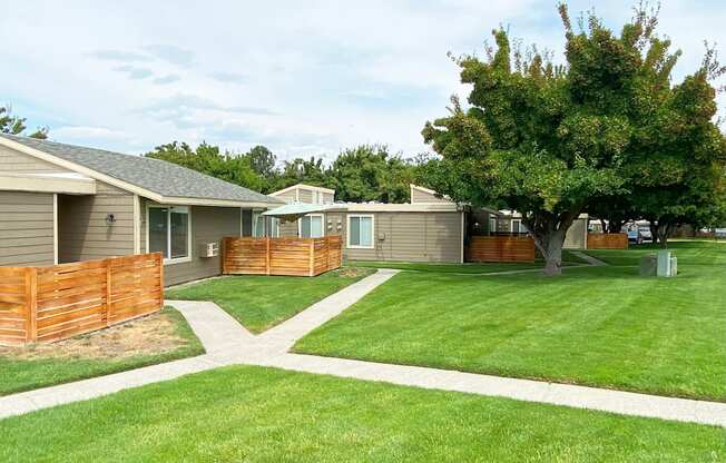 Green grass pathway leading to private homes at Park View Apartments in Wenatchee, WA