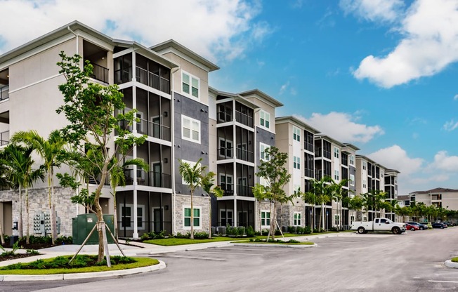 Vantage apartment building with trees and a parking lot