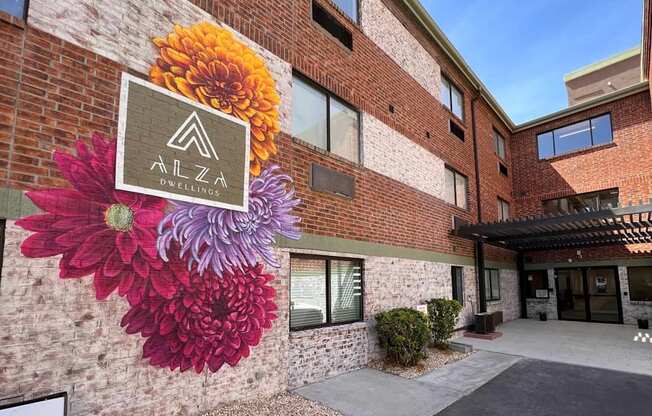 a mural of three flowers on the side of a building