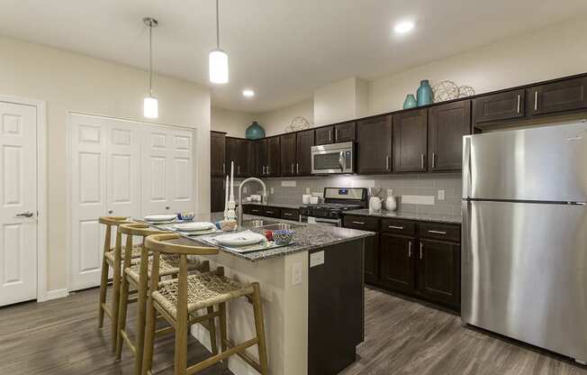 Kitchen with wooden cabinets and breakfast bar at The View at Horizon Ridge, Nevada, 89012