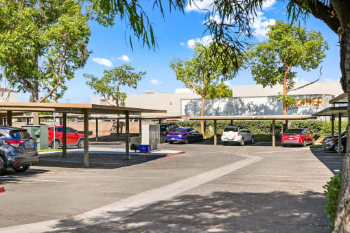 a parking lot with cars in front of a building