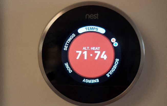 a digital thermostat on a wall