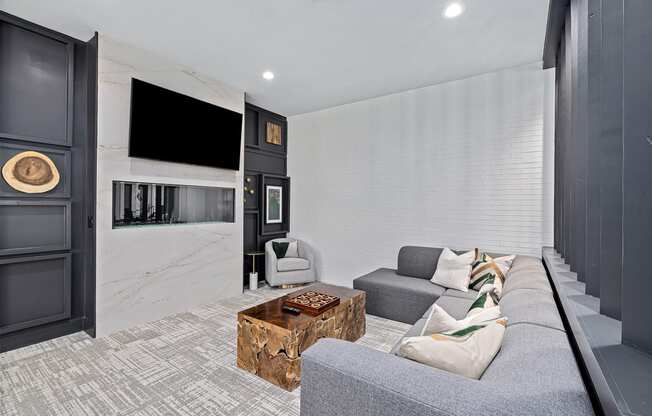 a living room with a gray couch and a television