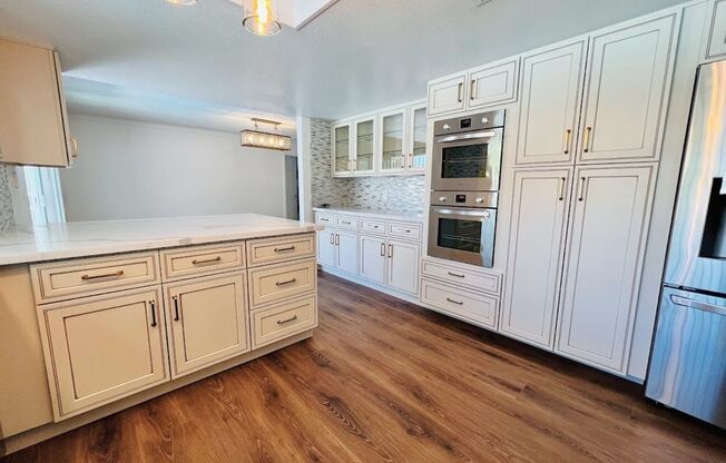 Gorgeous 4 Bed 2.5 Bath in a prime location! Home is over 2200 Sq Ft with a pool on a huge lot! Separate living room, dining room, and family room! Beautiful kitchen with stainless steel appliances built into the white cabinets!