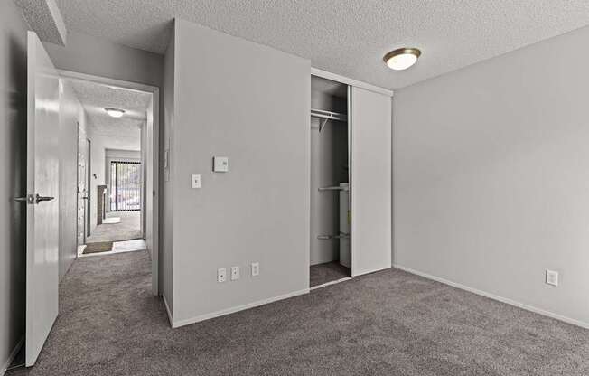 A room with a carpeted floor and white walls.