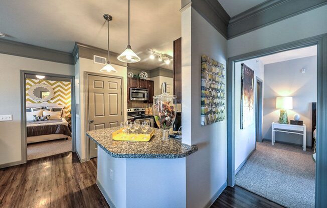 a kitchen with a granite counter top and a door to a bedroom  at Waterstone at Cinco Ranch, Katy, Texas