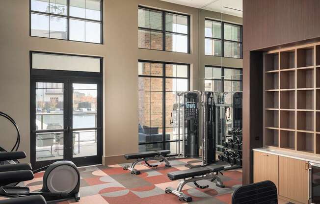A gym with a variety of equipment including weights and cardio machines.