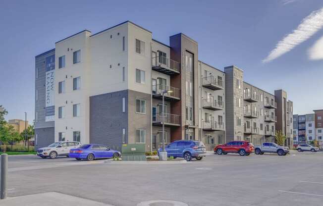 a picture of an apartment building with cars parked in front of it at Copper 87, West Jordan, 84088