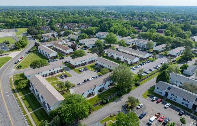 A bird's eye view of a residential area with houses and cars.
