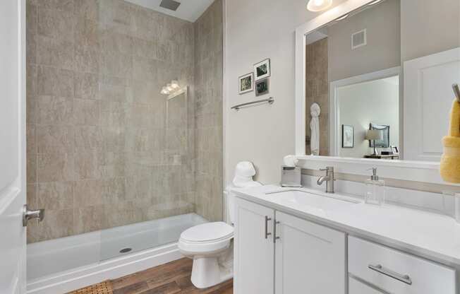 a bathroom with a sink and a toilet and a tub at Hayden Lofts, Dublin, OH