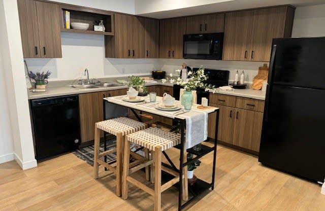 a kitchen with a bar with three stools