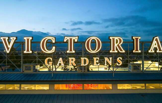 Victoria Gardens Sign Lit in Evening