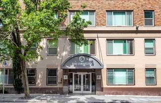 Building with a tree in front of it.