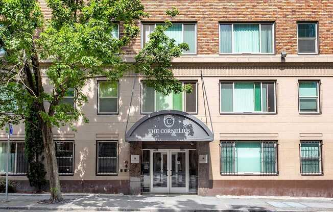 Building with a tree in front of it.