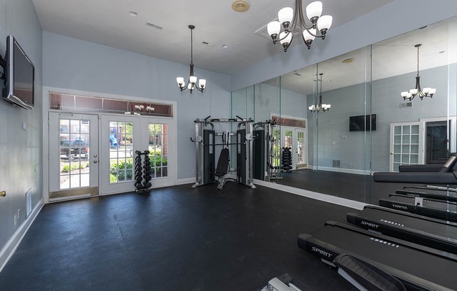 Fitness center with dumbells and cardio equipment