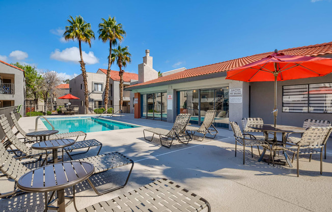 our apartments have a pool and patio with chairs and tables