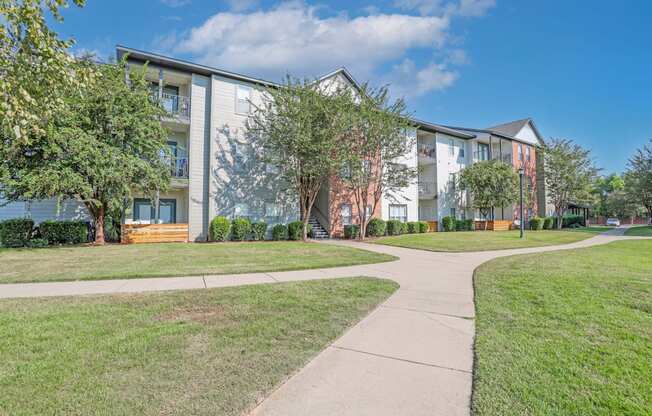 Apartment complex with a walkway in front at Ultris Island Park in Shreveport, LA