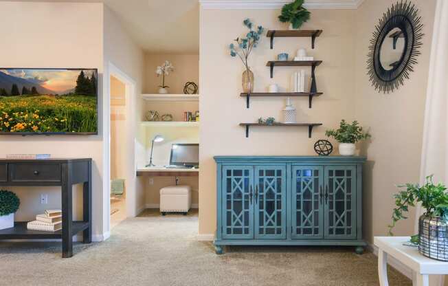 a screenshot of a room with a staircase and a wall with a clock and plants