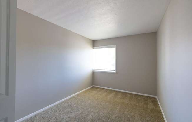 Third Bedroom with a Window in the Three Bedroom Townhome at Woodbridge Bloomington