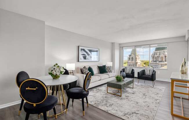 a living room with a white couch and a window with a view of a church