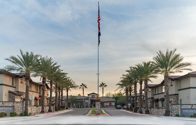 a flag pole with an american flag at the end of a street