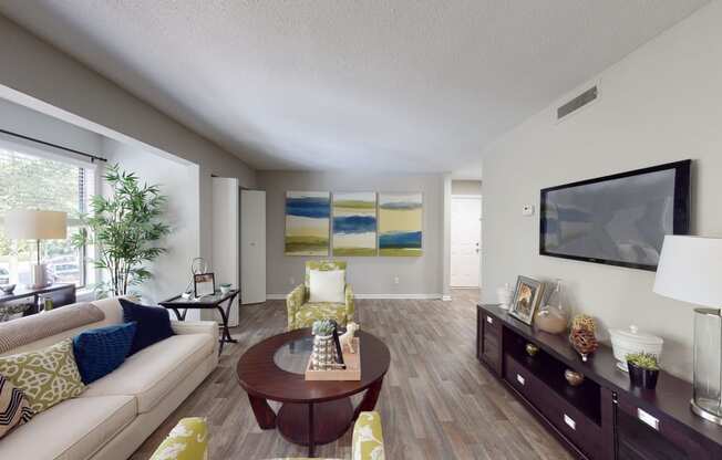 a living room with a couch coffee table and a tv