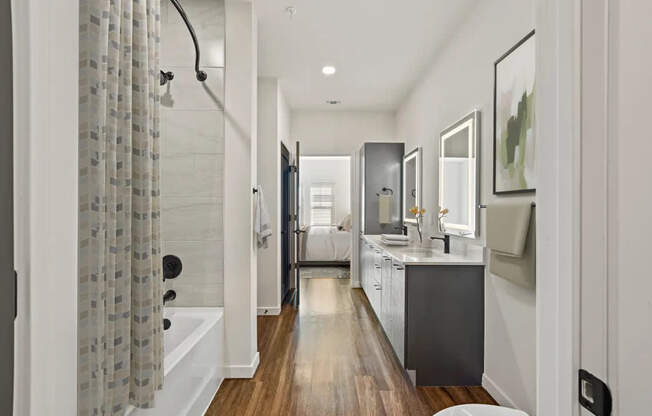 A modern bathroom with a walk-in shower and a vanity.