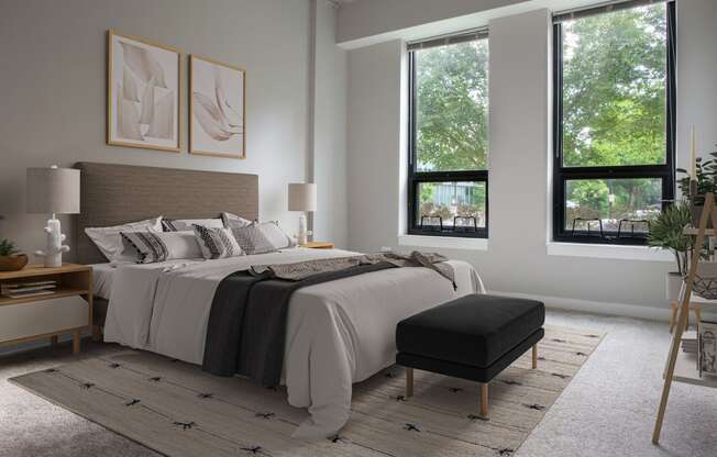 a bedroom with a bed and two windows