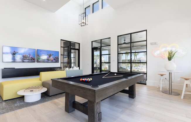 a pool table and sofa in Lake Nona Concorde clubhouse