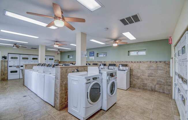 Laundry Room with dryers on both sides and washers in the center of the room