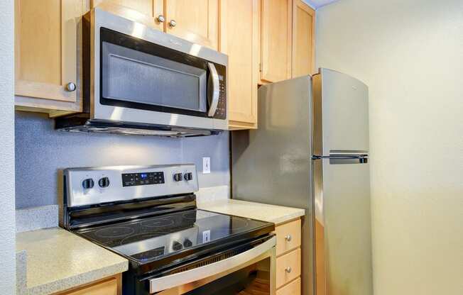 a kitchen with stainless steel appliances and wooden cabinets