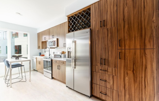 a kitchen with wooden cabinets and a stainless steel refrigerator at Dey & Bergen, Harrison