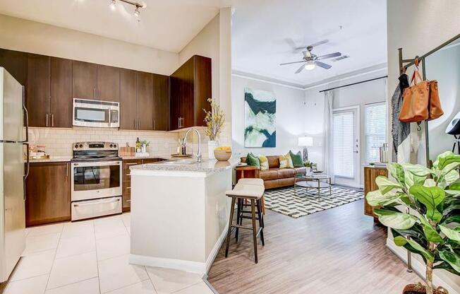 a kitchen with a bar and a living room