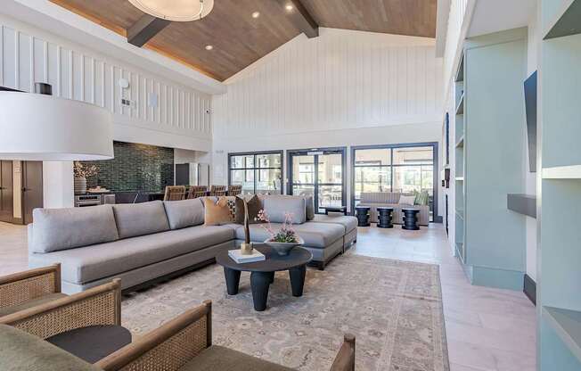 a living room with blue and white furniture and windows