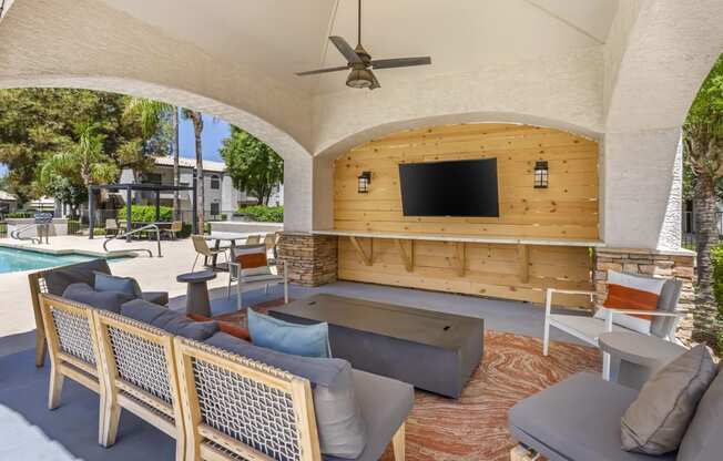 Relax in style by the pool with our comfy seating and entertainment at Boulders at Lookout Mountain Apartment Homes, Phoenix, AZ 85022