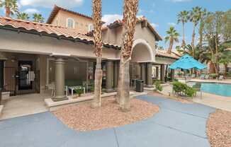 A house with a pool and a palm tree in front.