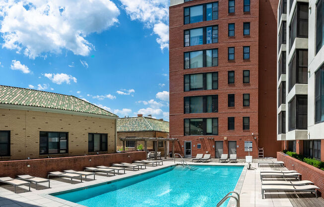 a swimming pool in the middle of two tall buildings