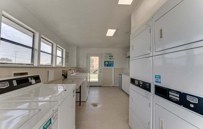 A laundry room with washers and dryers.