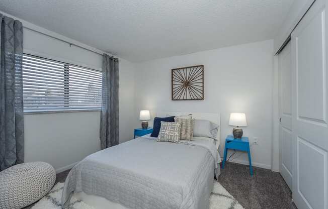 Bedroom with cozy bed and window at Mallard Landing Apartments , Marion, OH