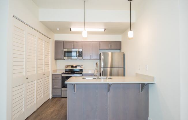 a kitchen with stainless steel appliances and a counter top